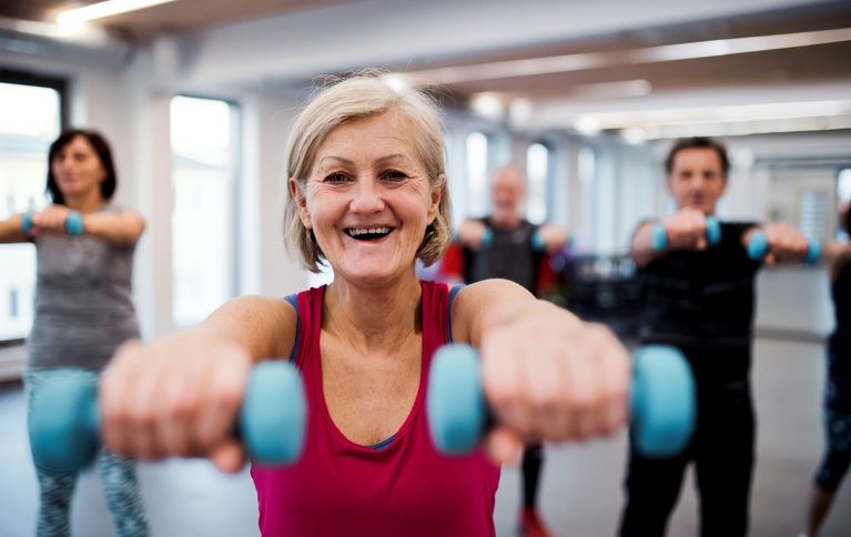Older woman with dumbells working out