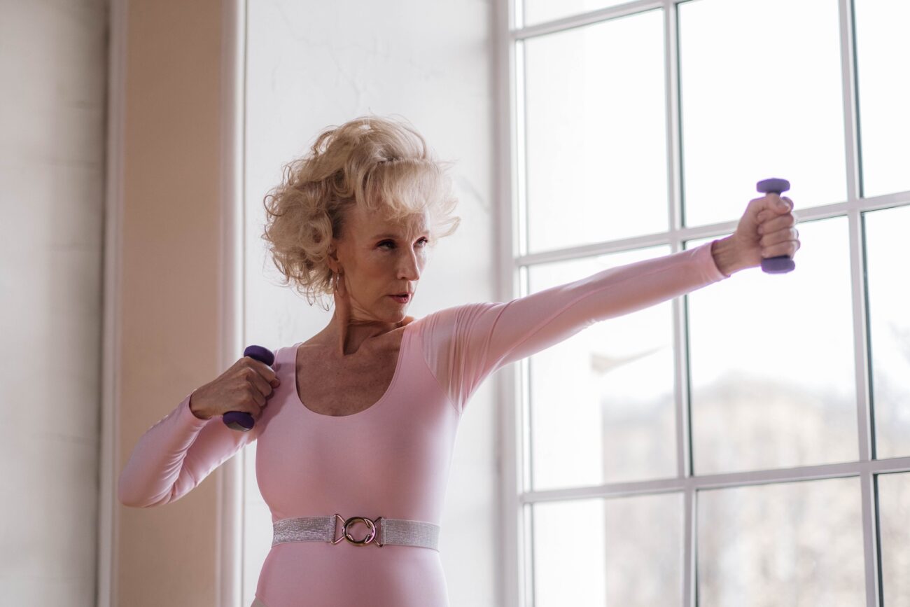 Photo of an older woman holding dumbells